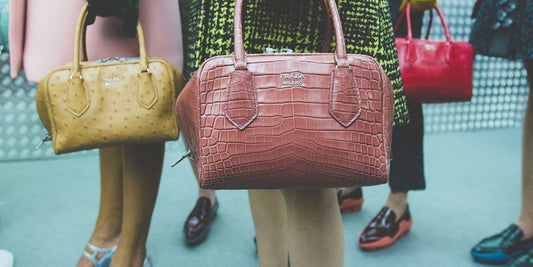 Prada ugly chic heritage, Prada Milano top handle bags in pink and ochre exotic leather carried backstage