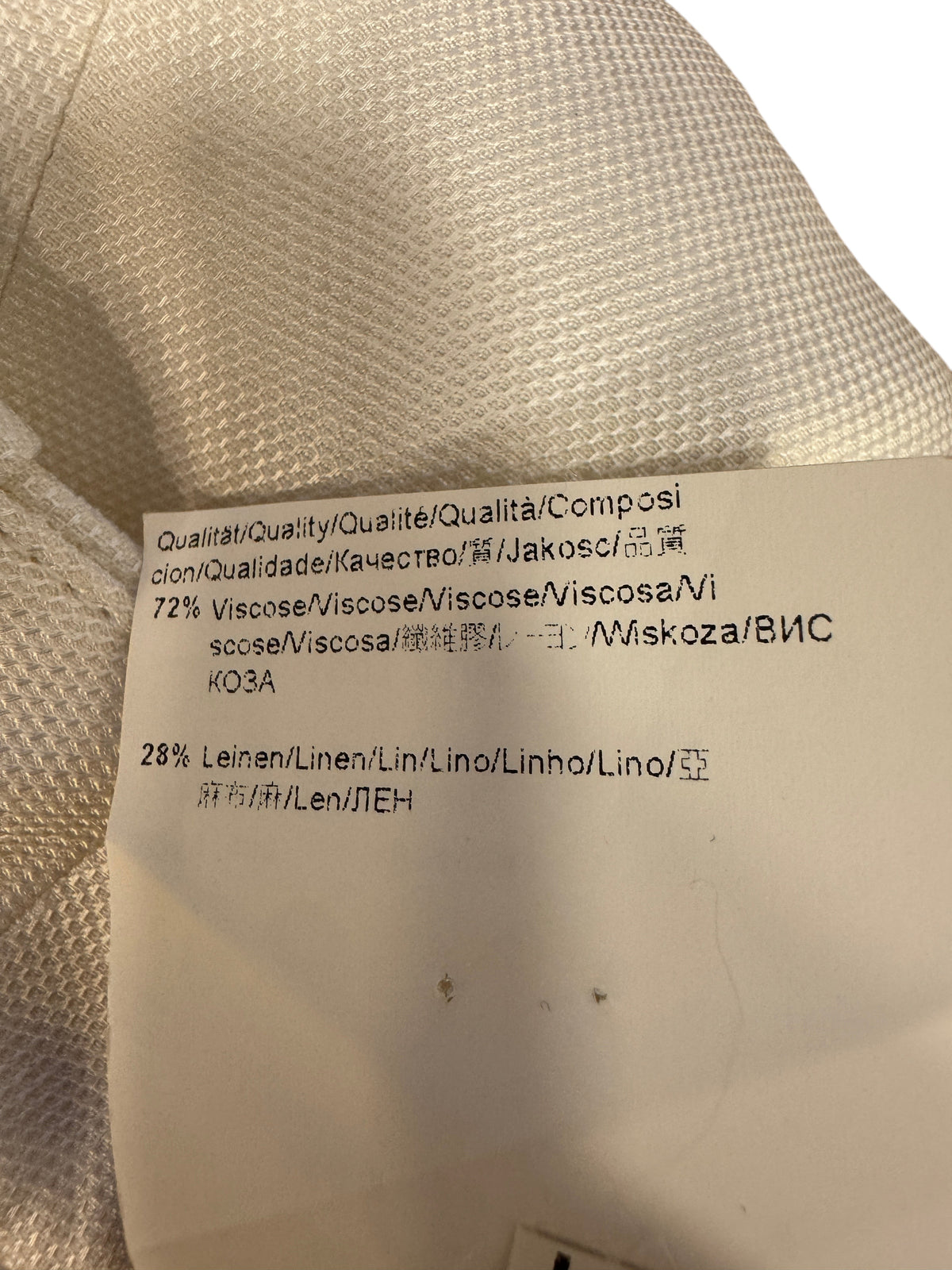Brandsamsara BOSS suit white fabric care label showing 72 percent viscose and 28 percent linen composition