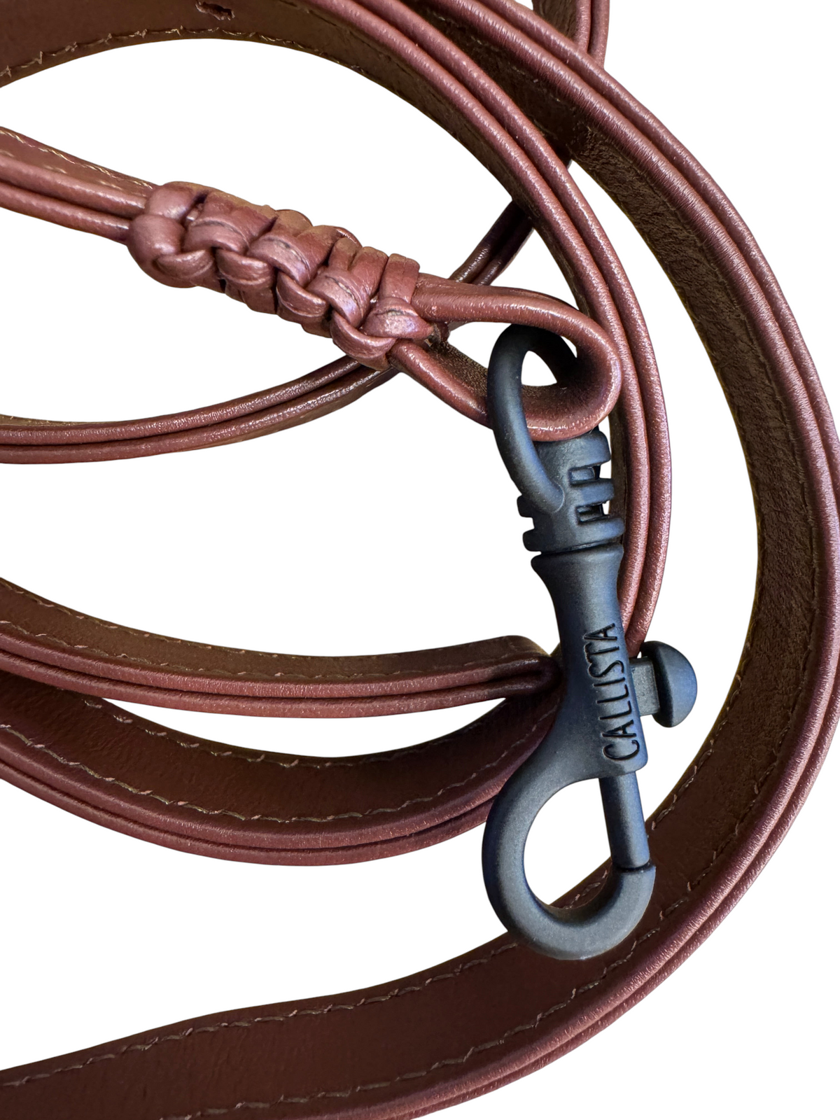 Brandsamsara Kallista brown leather handbag strap with braided detail and black metal clasp on wooden background
