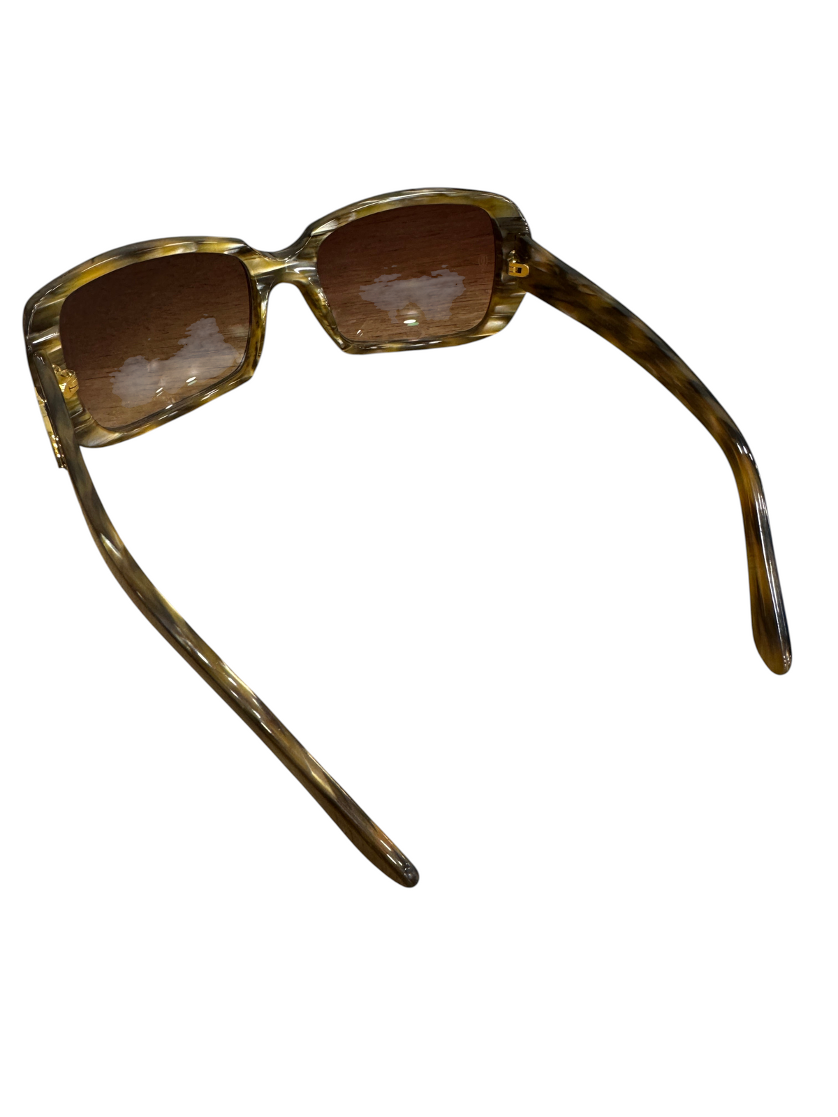 Brandsamsara Cartier sunglasses featuring a tortoiseshell acetate frame and medium tint lenses on a wooden surface.