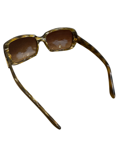 Brandsamsara Cartier sunglasses featuring a tortoiseshell acetate frame and medium tint lenses on a wooden surface.