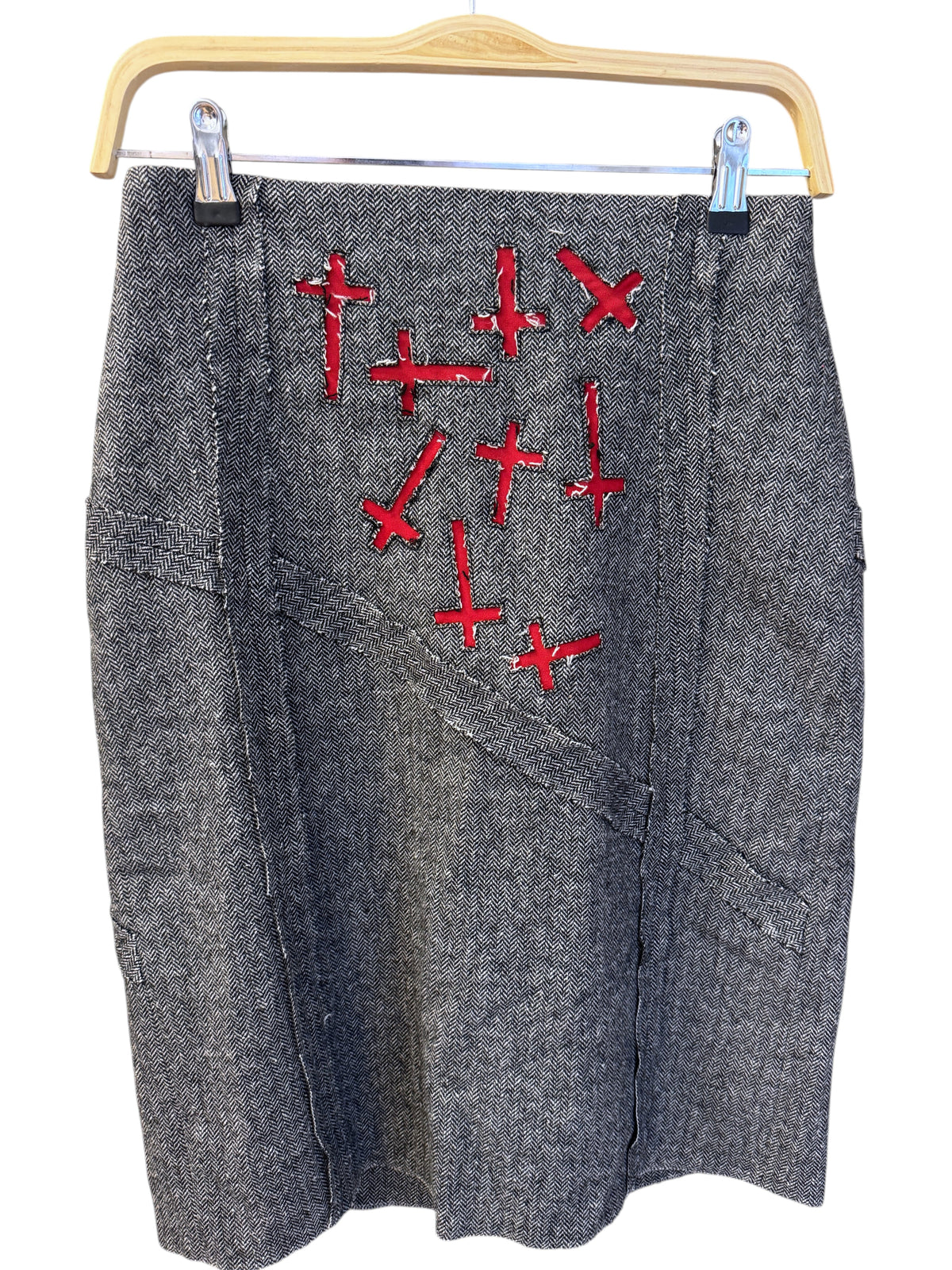 Brandsamsara Andy Warhol grey wool blend skirt with red embroidered cross details hanging on a wooden hanger