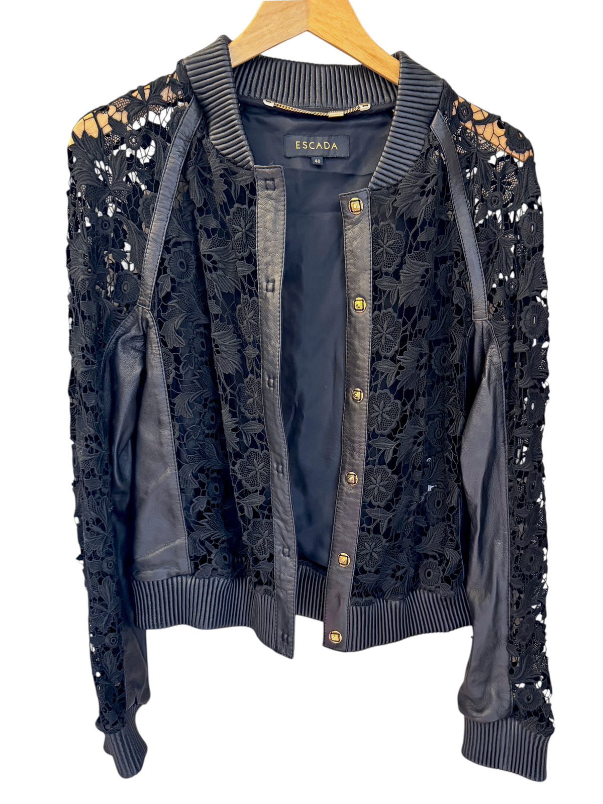Brandsamsara Escada black leather jacket featuring intricate floral lace panels and gold button front closure.