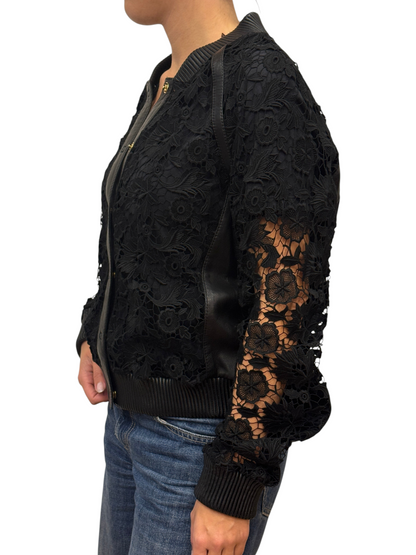 Brandsamsara black leather jacket featuring intricate floral lace panels and ribbed trim worn by a model