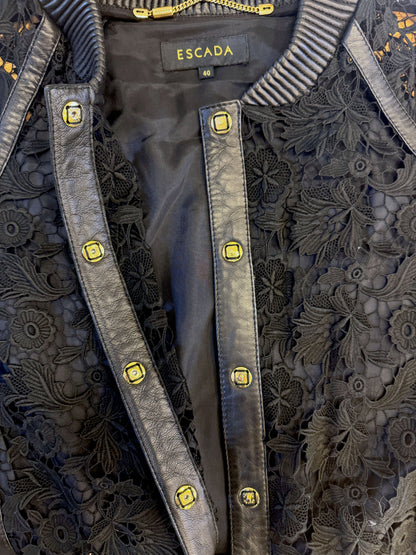 Brandsamsara Escada black leather jacket featuring intricate floral lace panels and gold-tone button detailing.