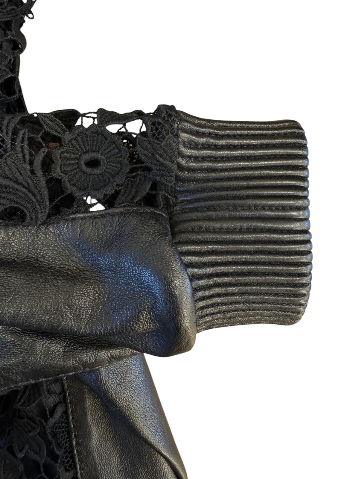 Brandsamsara Escada black leather jacket sleeve featuring intricate floral lace panels and ribbed cuff detail