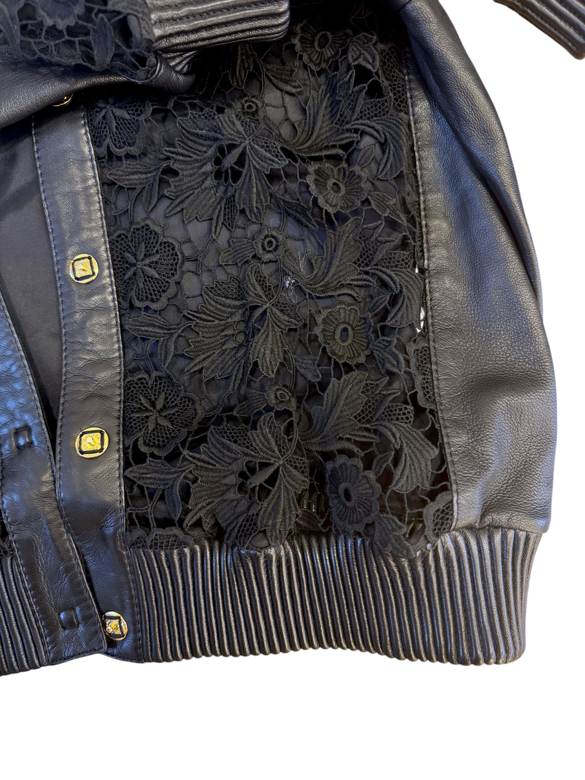 Brandsamsara Escada black leather jacket featuring intricate floral lace panels and gold-tone button detailing.