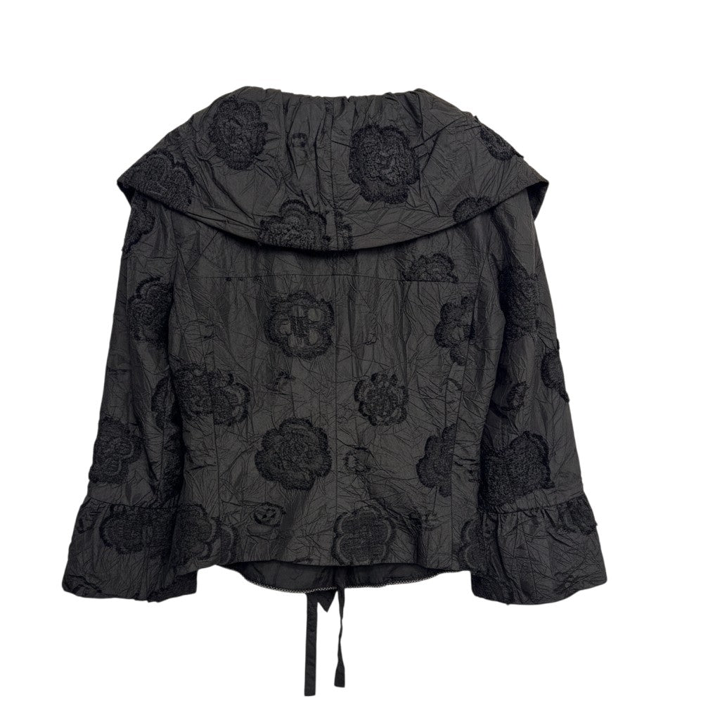 Brandsamsara black textured shirt with floral embroidery and ruffled cuffs, featuring a tie closure at the hem.