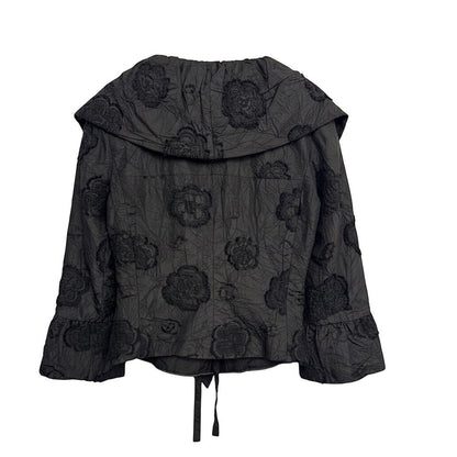 Brandsamsara black textured shirt with floral embroidery and ruffled cuffs, featuring a tie closure at the hem.