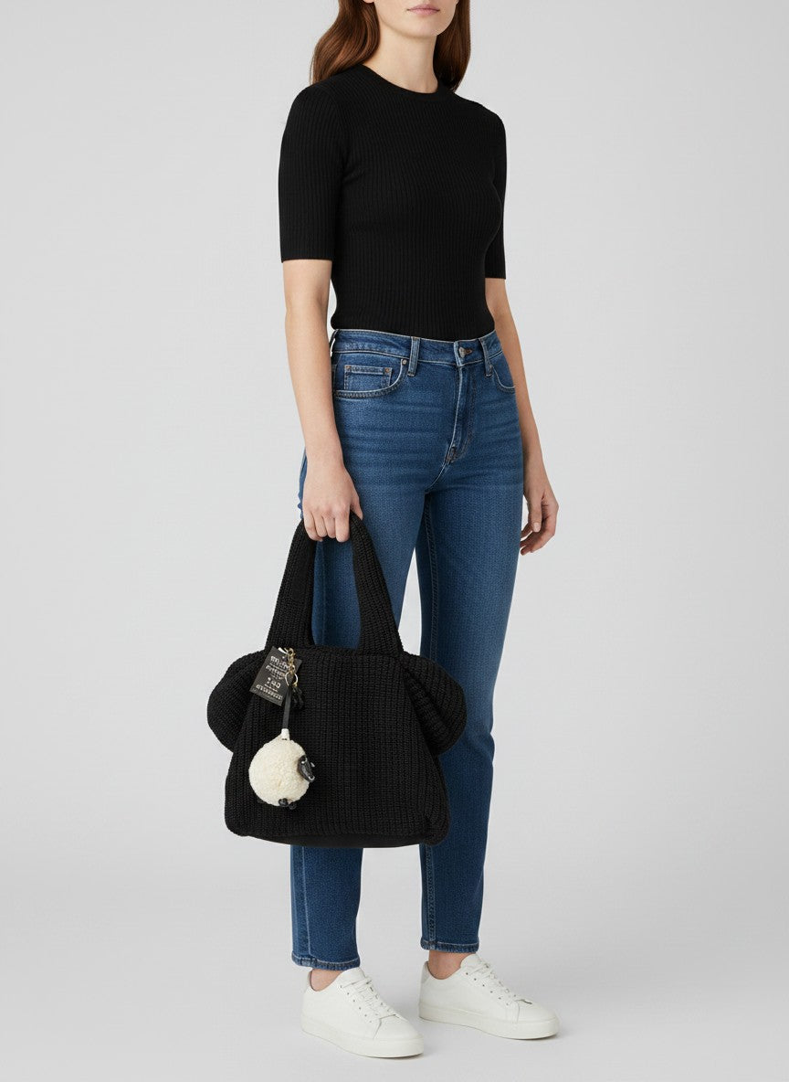 Brandsamsara black knitted shoulder bag with leather details and a sheep charm. Features cotton lining and leather bottom panel.