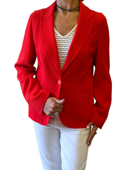 Brandsamsara orange Escada long sleeve jacket with a single button closure and front pockets worn by a model