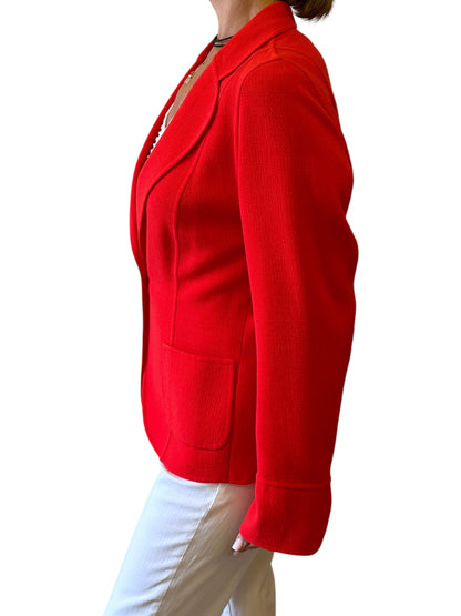 Brandsamsara orange Escada long sleeve jacket with a textured finish and front pockets, worn by a model.